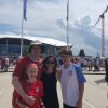 Mike Trucano (left) and his family pose in front of the stadium hosting the final for the 2019 Women's World Cup in Lyon, France,.
