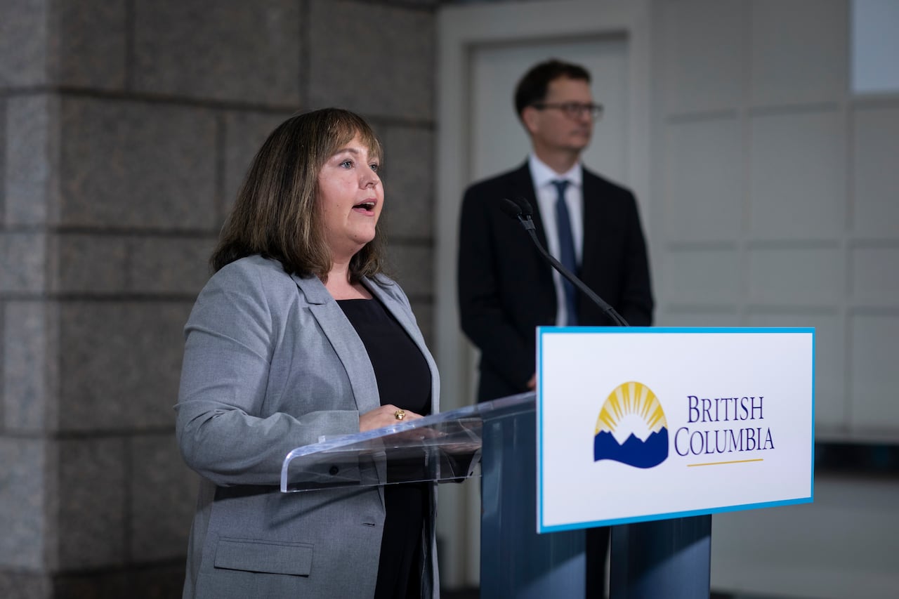 A woman with shoulder-length hair speaks at a podium marked 'British Columbia'.