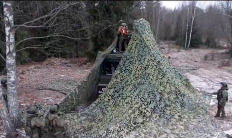 The video showed troops putting camouflage and netting over the systems.