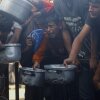 Displaced Palestinians wait in long lines for a charitable meal under crowded tents in Khan Younis, Gaza Strip, on Tuesday, as food scarcity worsens under the ongoing siege. Women and children rely on small charity kitchens to feed thousands amid a daily struggle for survival.