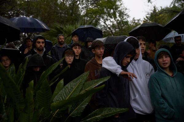 Mourners gather for the funeral of Aviv Maor, 19, an Israeli who killed by a Palestinian attacker last week, at kibbutz ein harod cemetery in northern Israel on Monday, Dec 29, 2025. (AP Photo/Ohad Zwigenberg)