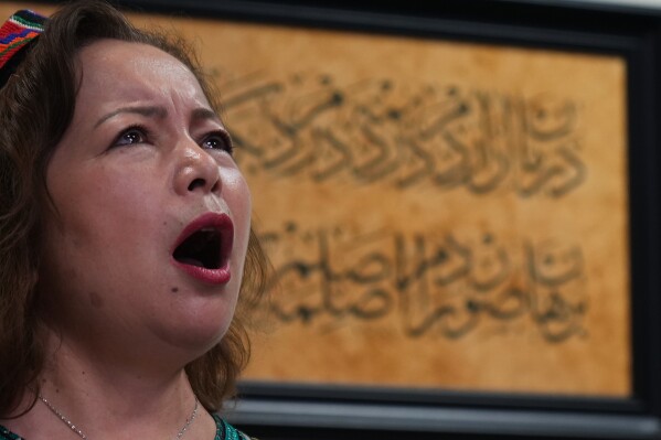 Rahima Mahmut, Uyghur human rights activist, performs with the London Uyghur Ensemble during an interview with The Associated Press in London, Wednesday, Oct. 8, 2025. (AP Photo/Joanna Chan)