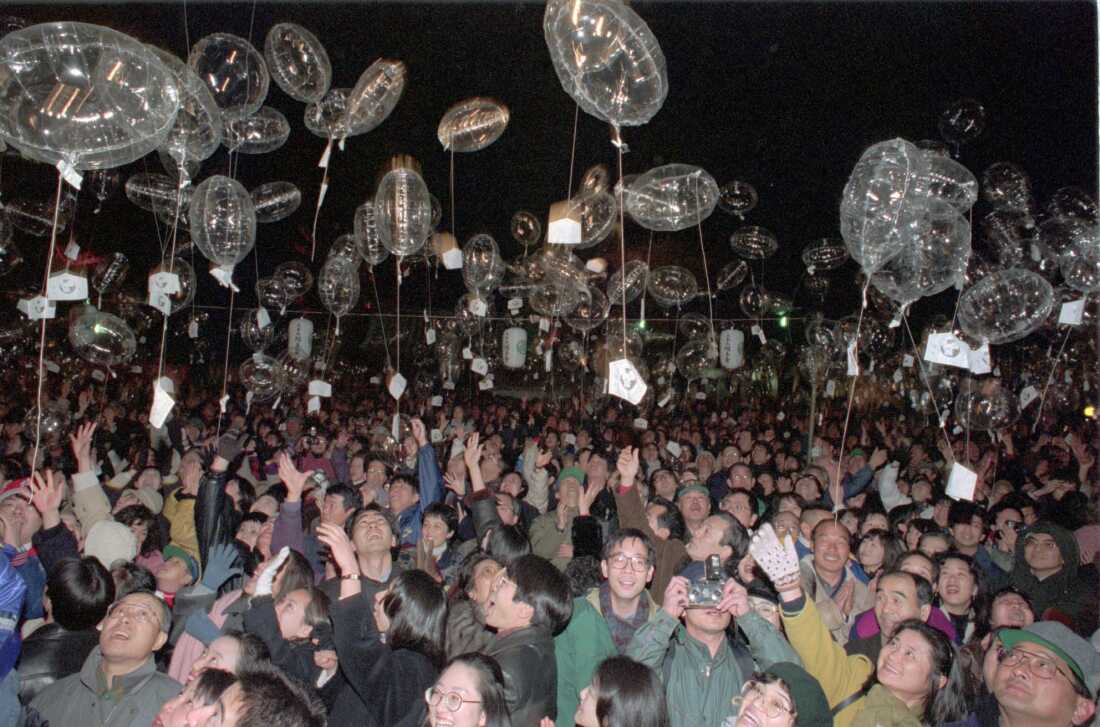 Revelers release New Year's resolutions attached to balloons at Tokyo's Zojoji Temple at the strike of midnight on Jan. 1, 1996.