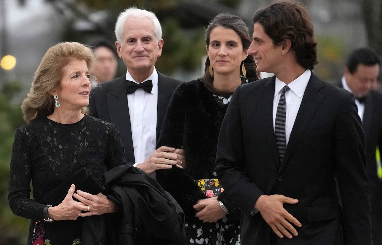 Two men and two women walking together, smiling