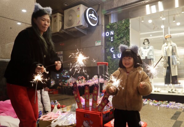 People cheer during the 2026 Taipei New Year's Party celebration in front of the Taipei City Government Building in Taipei, Taiwan, Wednesday, Dec. 31, 2025. (AP Photo/Chiang Ying-ying)