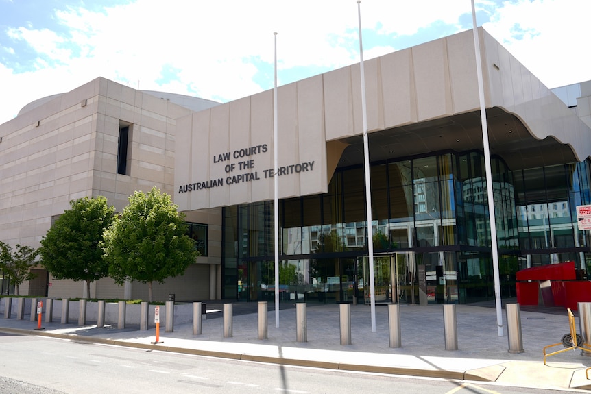 A young man leaves court.