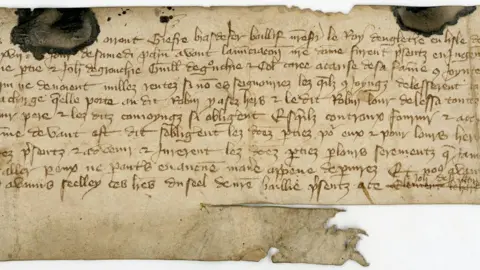 Jersey Heritage An old written document on brown paper.