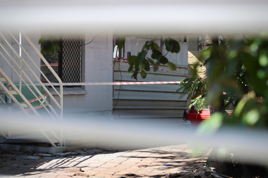 Police crime scene tape outside a house.