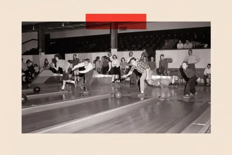 Getty Images A black and white image of young men and women bowling.