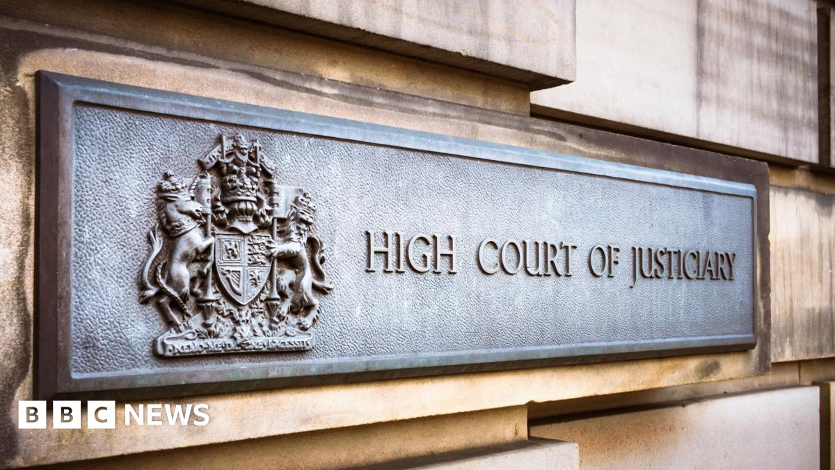 Close up of bronze sign saying High Court of Justiciary