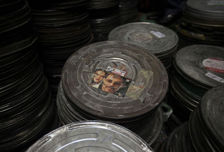 A film can with a picture of a Bollywood movie is seen inside the storage room at Ariana Cinema in Kabul.