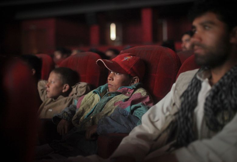 Cinema goers watch a Bollywood film at Ariana Cinema in Kabul.