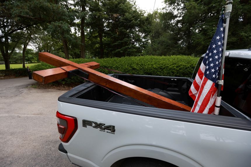 Beazley's cross lies in his pickup at a memorial for Corey Comperatore, the former volunteer fire chief killed during the attempted assassination of Donald Trump at a campaign rally, in Freeport, Pennsylvania, on July 18, 2024.