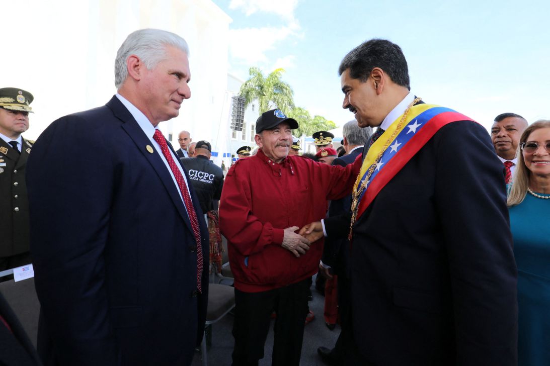 Venezuelan President Nicolás Maduro shakes hands with Nicaraguan President Daniel Ortega as Cuban President Miguel Díaz-Canel looks on on the day of Maduro's inauguration for a third six-year term in Caracas, Venezuela, on January 10.
