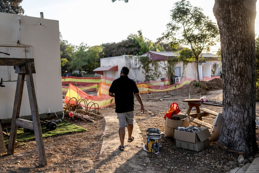 Avishay Edri, 41, walks on a path near the home he is returning to after he was evacuated following the October 7, 2023, attack in Kibbutz Nahal Oz in southern Israel, October 30, 2025.