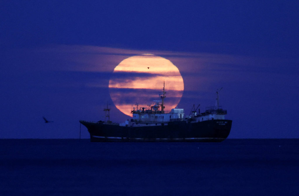 The Cold Moon, the last supermoon of 2025, lights up the sky in the Strait of Magellan in Punta Arenas