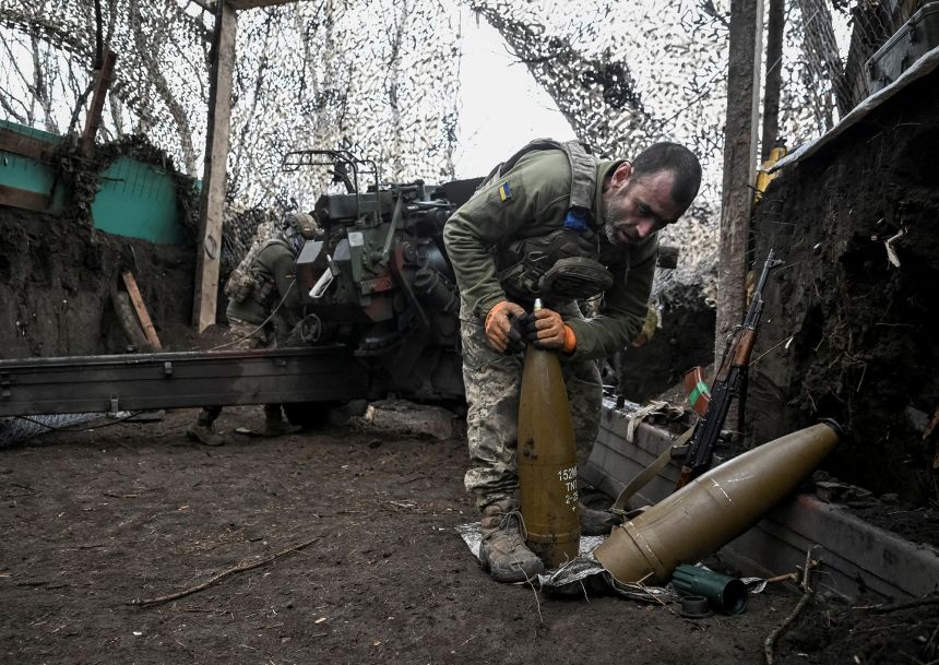 An Ukrainian artilleryman prepares shells for a howitzer as servicemen fire towards Russian troops near the frontline town of Pokrovsk in the Donetsk region, on December 11.