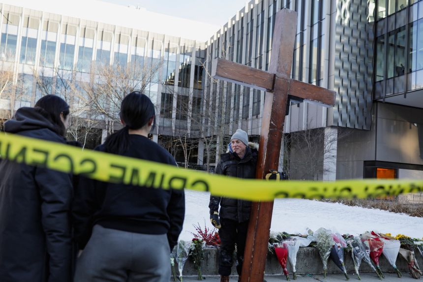 Beazley speaks with students December 15 while holding his cross in front of the Barus & Holley engineering building at Brown University, where students were shot, in Providence, Rhode Island.
