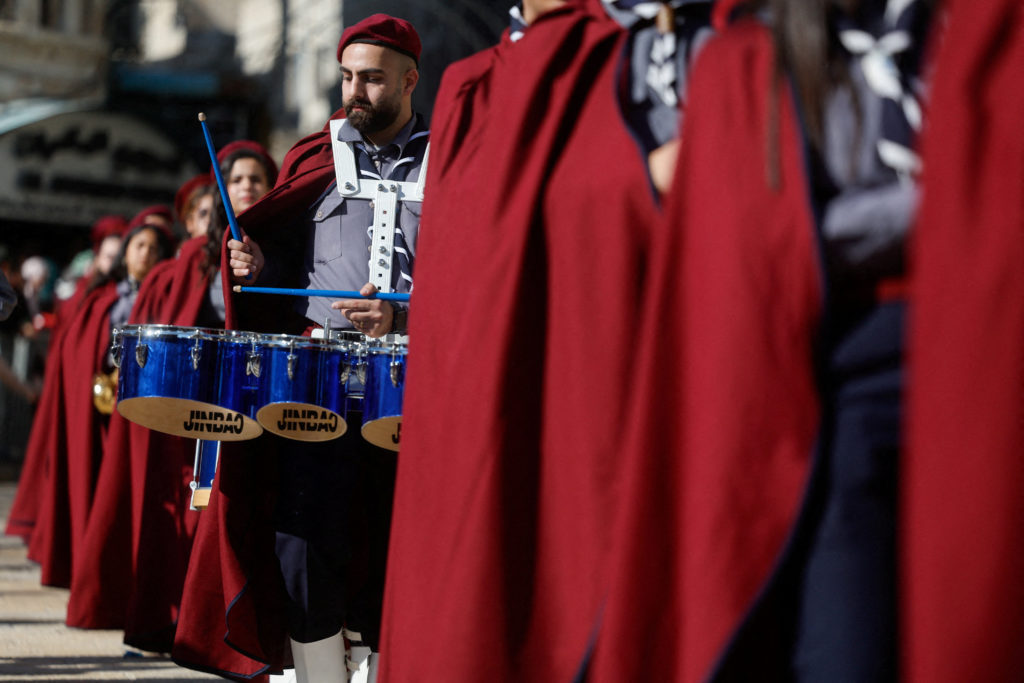 Palestinian scouts parade at Manger Square outside the Church of the Nativity in Bethlehem