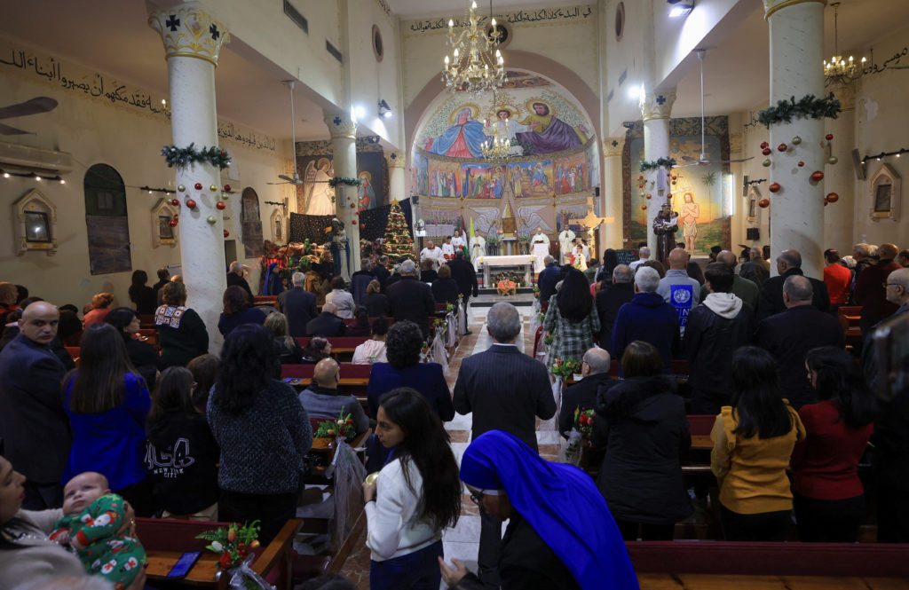 Palestinian Christians attend a Mass on Christmas Eve, at the Holy Family Church, in Gaza City