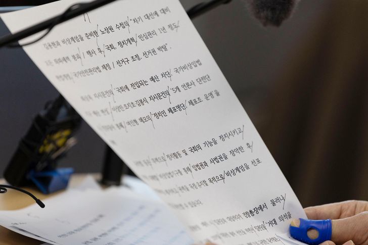 Special counsel Cho Eun-seok announces the final results of a six-month investigation into former President Yoon Suk Yeol's martial law declaration, during a press briefing at the Seoul High Prosecutors’ Office in Seocho District, Seoul, Monday. A document bearing the words “politicians arrest list” is shown. Joint Press Corps