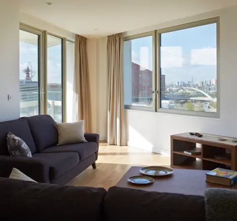 View Pictures via Getty Images The view from a living room with sofas and a coffee table inside a flat at East Village in Stratford, overlooking the Olympic park