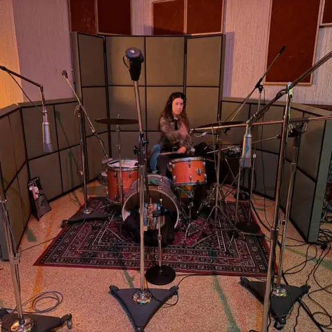 Haim / Rostam Danielle Haim plays the drums while recording the album I Quit