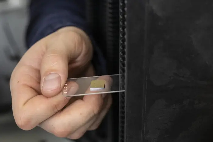 research slide in hand ready for microscope