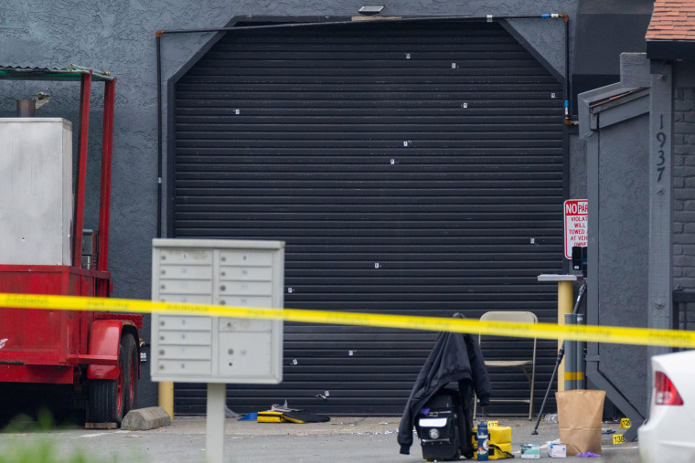 A garage door is pictured behind crime scene tape.