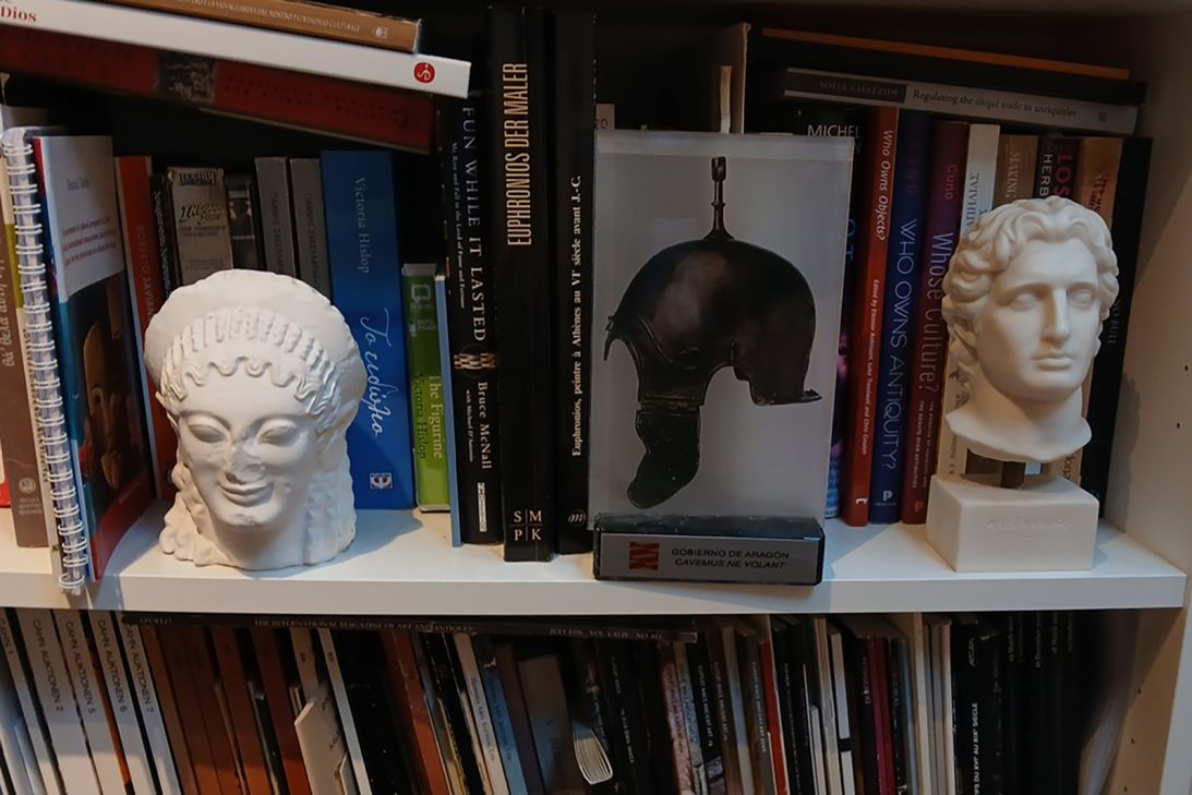 Objects on a bookshelf of Christos Tsirogiannis, who has devoted his career to tracking down illicit antiquities