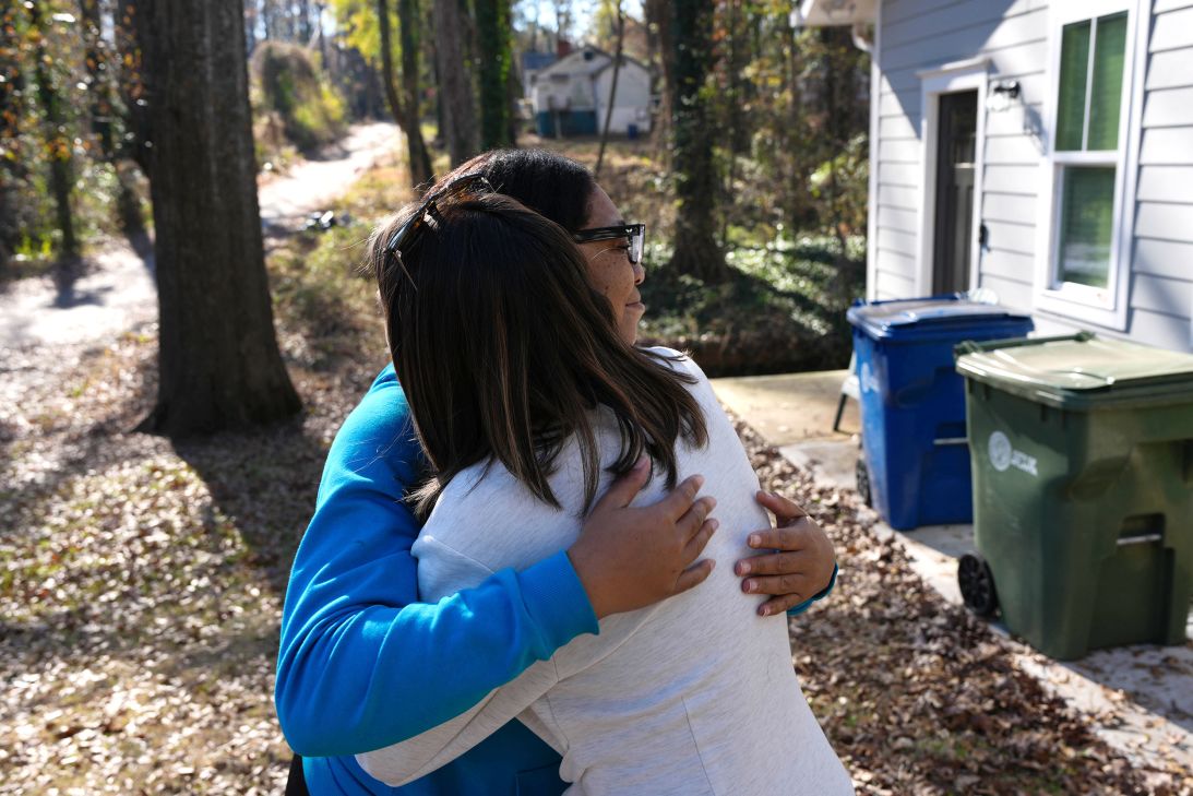 Ogechi Irondi, left, and Jamey Jones embrace after meeting in person for the first time. Jones saw a post about Irondi's work ethic and setbacks and decided to help her family buy groceries.