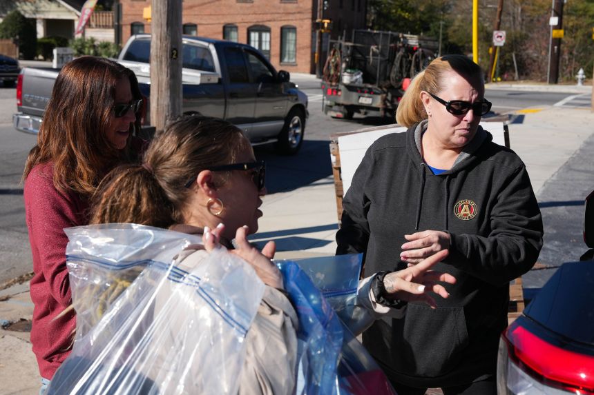 Christy Betz, founder of Giving Grace, sorts through donated items in Atlanta