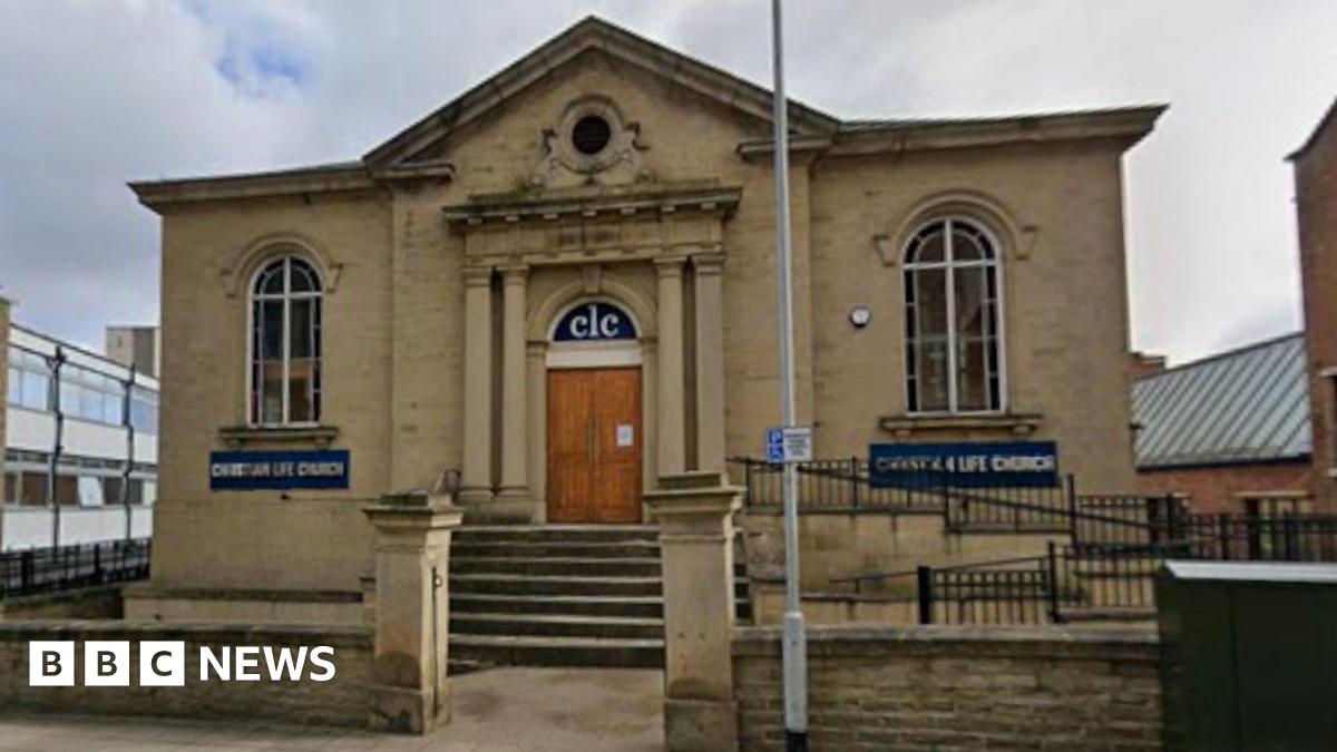 The outside of the Wesleyan Reformed Church building, a stone-brick building. The building has steps leading up to double wooden doors.