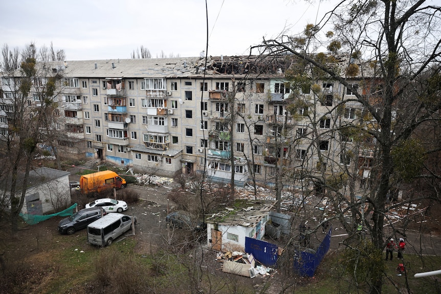 Emergency responders work at the site of a Russian drone strike on an apartment building