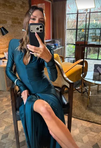 Victoria Beckham / Instagram Beckham paired the dress with a pendant necklace and a few statement pieces of jewelry