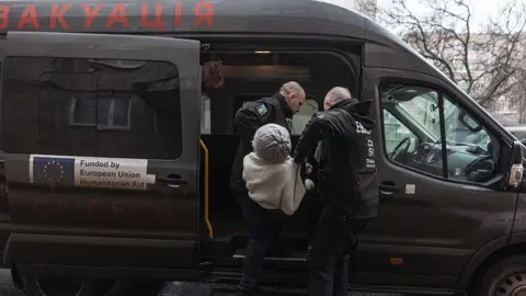 Anadolu via Getty Images Workers from the organisation East SOS evacuate 92-year-old Valentina due to continuous Russian attacks on the city of Sloviansk