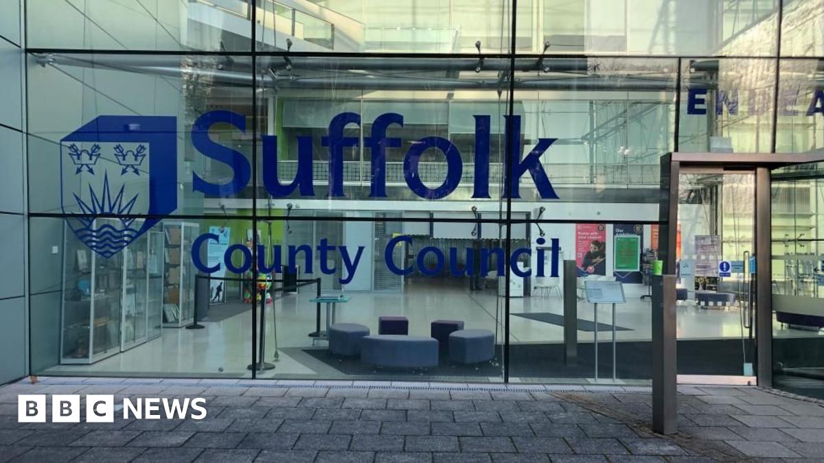 The glass-fronted Suffolk County Council building, with the council's logo in blue.