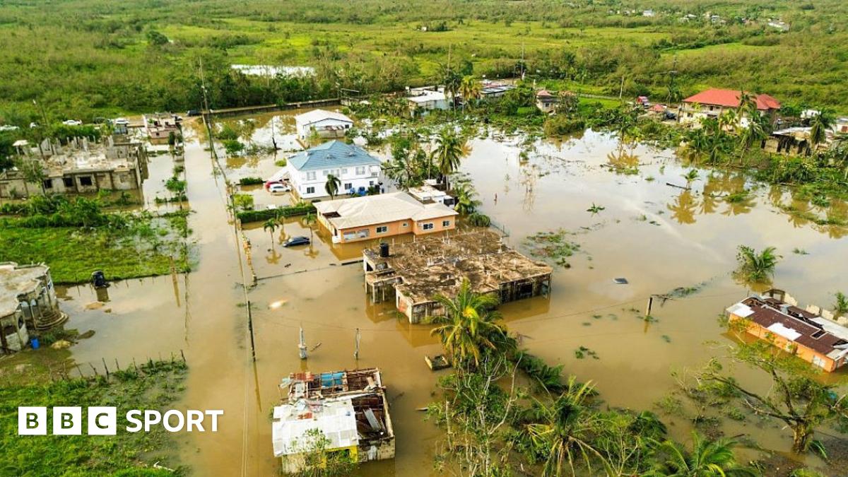 Jamaica netball player Shanice Beckford holds an aid package