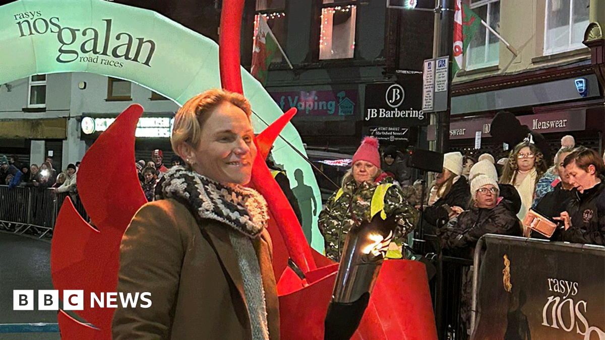 Jess Fishlock, pictured in the street of Mountain Ash town centre, holds a lit torch used to herald the start of the annual race