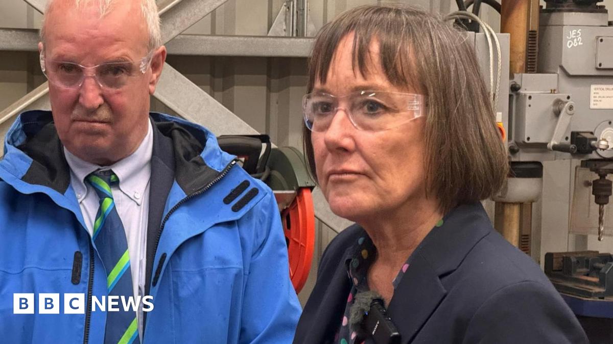 Jo Stevens wearing protective goggles while visiting an engineering firm.