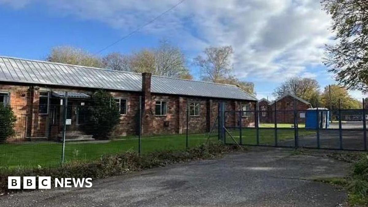 An exterior view of Crowborough Training Camp form outside the perimeter fence and locked gates.