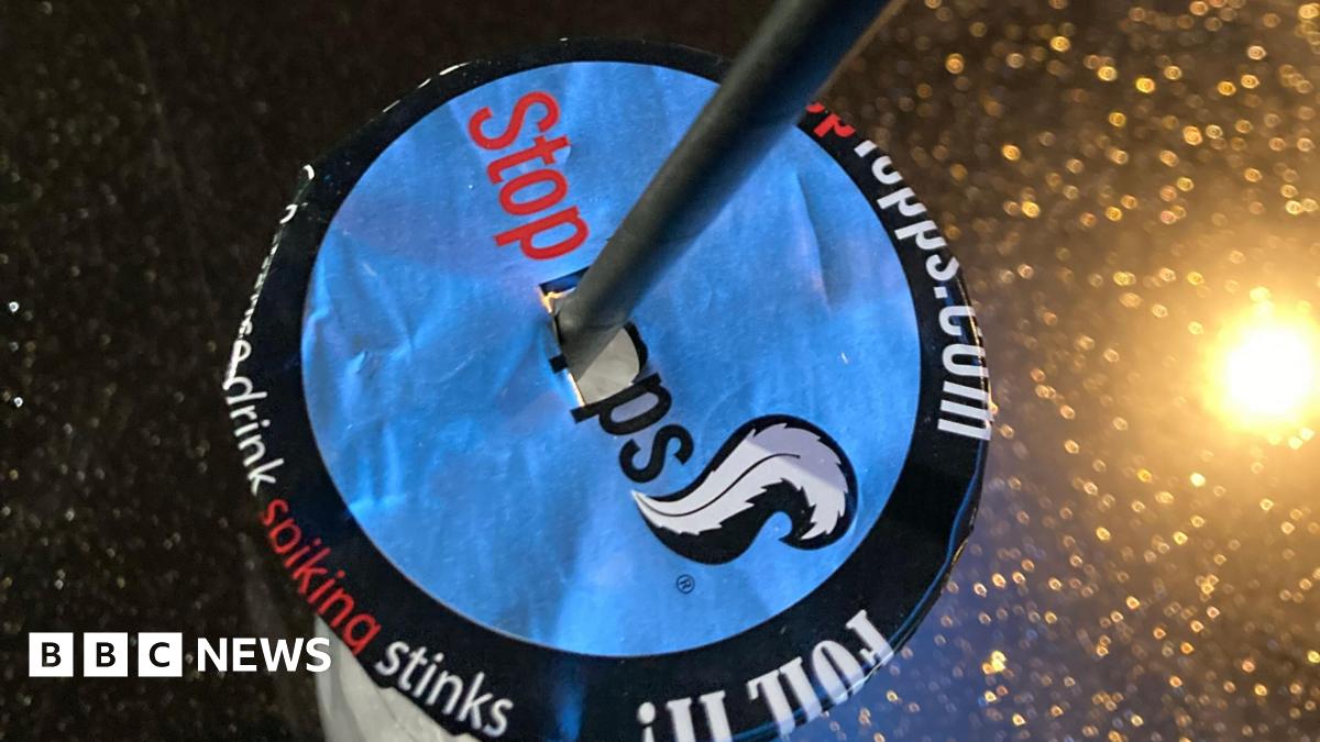 A drink with a cover on top of it to prevent spiking