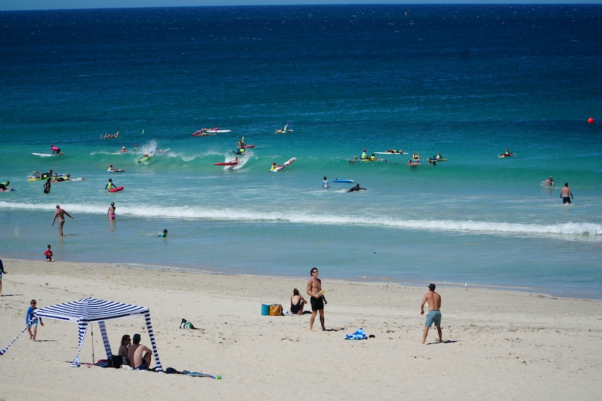 Surf life saving kids take part in training on Trigg Beach.