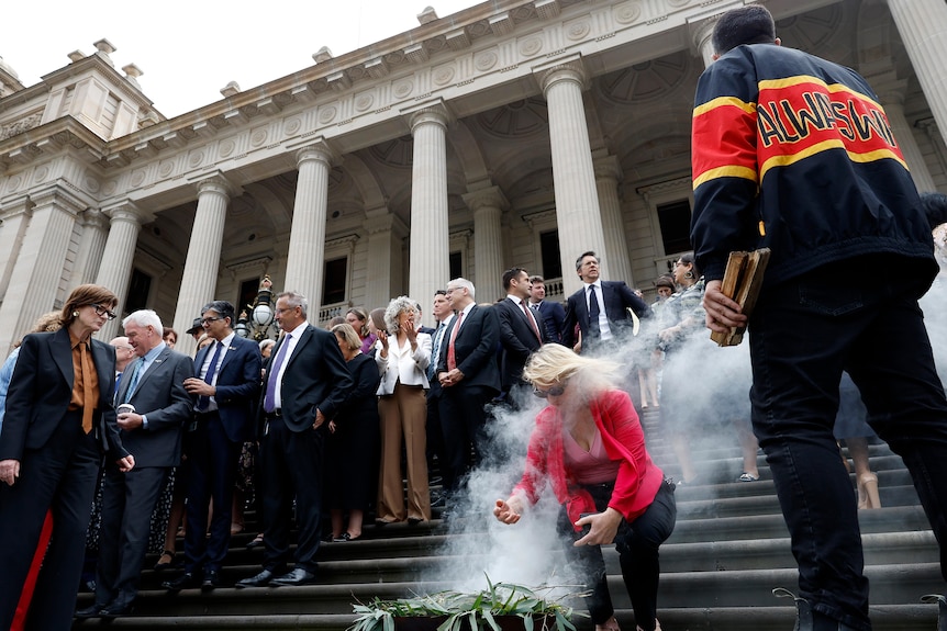 A smoking ceremony on the steps of Victorian Parliament