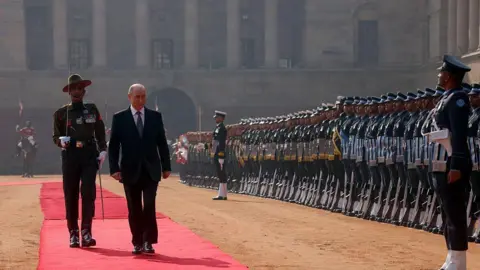 AFP via Getty Images In this pool photograph distributed by the Russian state agency Sputnik, Russia's President Vladimir Putin inspects a guard of honour during his ceremonial reception at India's presidential palace, Rashtrapati Bhavan, in New Delhi on December 5, 2025.