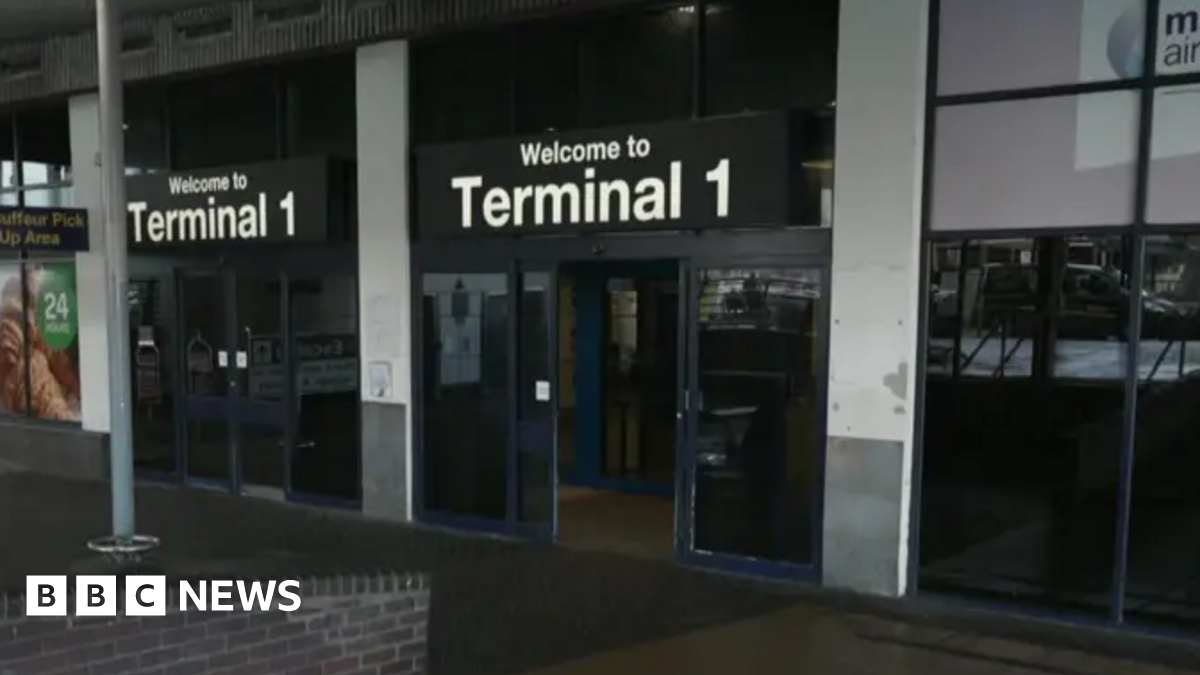 The exterior of an entrance into Manchester Airport terminal one.
