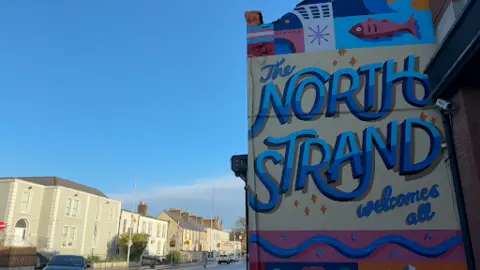 Colourful mural with words North Strand Welcomes All in north Dublin