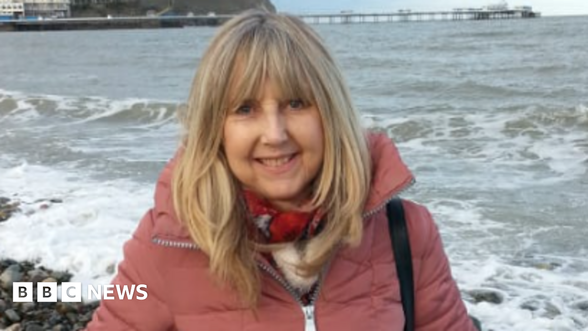 Machado smiles as she looks at a supporter and holds her hands together in a prayer motion
