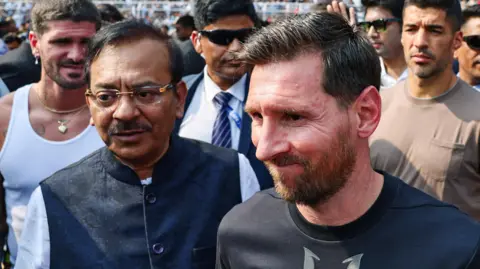Reuters Lionel Messi, surrounded by Indian officials, during a stadium visit in Kolkata.