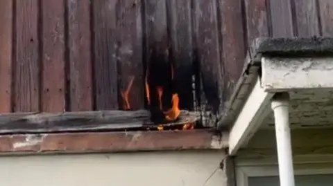 Handout Burning cladding on the outside of a house. 